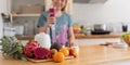 Beauty healthy asian woman making fruit smoothie with blender. woman drinking glass of fruit smoothie in kitchen. Diet Royalty Free Stock Photo