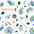 Beauty hydrangea flowers with cosmetics on white background. Flat lay, top view. Floral background