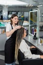 beauty industry, braids, happy hairdresser braiding Royalty Free Stock Photo