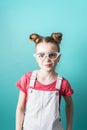 Beauty industry: A girl with glasses admires her false eyelashes.