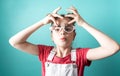 Beauty industry: A girl with glasses admires her false eyelashes.