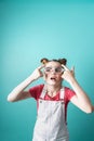 Beauty industry: A girl with glasses admires her false eyelashes.