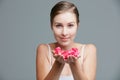 Beauty inspired by the softness of petals. Studio portrait of an attractive young woman holding a handful of pink petals Royalty Free Stock Photo