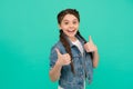 Beauty at its best. Happy child give thumbs up blue background. Little girl smile gesturing thumbs up. Hair salon