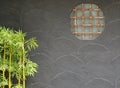 The beauty of Japanese decorative design window on the abstract gray cement wall with small bamboo tree Royalty Free Stock Photo