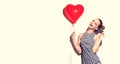 Beauty joyful teenage girl with heart shaped air balloon