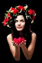 The beauty lady is wearing rose crown on her head,rose petals in hands Royalty Free Stock Photo