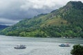 The Beauty Landscape of Lake Toba with boats, mountain, sky, and lake in one frame a popular tourist destination in Sumatera Utara Royalty Free Stock Photo