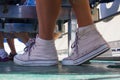 Beauty legs. Pink sneakers on the ship