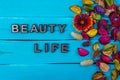 Beauty life text on blue wood with flower