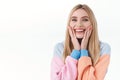 Beauty, lifestyle and fashion concept. Close-up portrait of cheerful, feminine blonde girl in hoodie, touching her