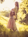 Beauty little girl with her Mother playing at nature. Royalty Free Stock Photo