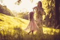 Beauty little girl with her Mother playing at nature. Royalty Free Stock Photo