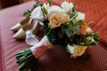 Beauty lush wedding bouquet near the bride`s shoes and perfume in blur
