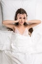 Beauty lying in the bed covering ears Royalty Free Stock Photo