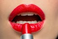 Close up of woman applying red lipstick to lips Royalty Free Stock Photo