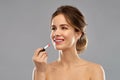 Woman with pink lipstick applying make up Royalty Free Stock Photo