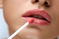 Beauty Makeup. Beautiful Woman Applies Lip Gloss