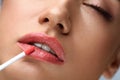 Beauty Makeup. Beautiful Woman Applies Lip Gloss