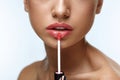 Beauty Makeup. Beautiful Woman Applies Lip Gloss