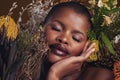 Beauty, makeup and plants with face of black woman in studio for natural, spa and environmental. Cosmetics, flowers and