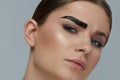 Beauty makeup. Woman coloring eyebrow with brow gel tint Royalty Free Stock Photo