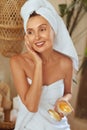 Beauty Mask. Woman In Bath Towel Applying Skin Care Product. Morning Routine As Part Of Anti-Aging Therapy.