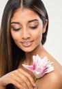 Beauty Model Face Make up. Woman with Natural Eyeshadow and Lips Makeup holding Flower on Shoulder. Women Facial and Body Skin Royalty Free Stock Photo