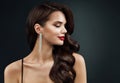 Beauty Model Face Profile with Red Full Lips Make up. Beautiful Woman Side view Curly Waves Hairstyle and Silver Earring over dark Royalty Free Stock Photo