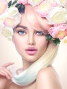Beauty model girl with colorful flowers wreath and colorful hair. Flowers hairstyle