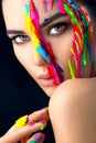 Beauty model girl with colorful paint on her face. Portrait of beautiful woman with flowing liquid paint Royalty Free Stock Photo