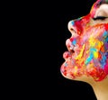 Beauty model girl with colorful paint on her face. Portrait of beautiful woman with flowing liquid paint Royalty Free Stock Photo