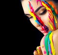 Beauty model girl with colorful paint on her face. Portrait of beautiful woman with flowing liquid paint