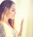 Beauty model girl looking out the window Royalty Free Stock Photo