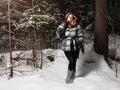 Beauty model girl in night winter forest. beautiful young Woman in fashionable Fur Coat and scarf Royalty Free Stock Photo