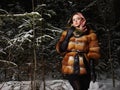 Beauty model girl in night winter forest. beautiful young Woman in fashionable Fur Coat and scarf Royalty Free Stock Photo