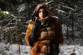 Beauty model girl in night winter forest. beautiful young Woman in fashionable Fur Coat and scarf Royalty Free Stock Photo