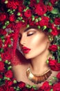 Beauty model girl with red roses flower wreath and fashion makeup Royalty Free Stock Photo