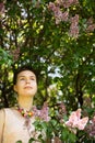 Beauty model girl wearing beads under lilac Royalty Free Stock Photo