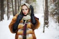 Beauty model girl in winter forest. beautiful young Woman in fashionable Fur Coat and scarf Royalty Free Stock Photo