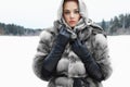 Beauty model in winter forest. beautiful young Woman in fashionable Fur