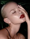 Beauty Model Woman with blonde slick Hair. Healthy Hair and Beautiful Professional Makeup. Red Lips and