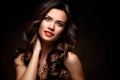 Beauty Model Woman with Long Brown Wavy Hair. Healthy Hair and Beautiful Professional Makeup. Red Lips and Smoky Eyes