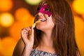 Beauty model woman wearing pink carnival mask in colorful background Royalty Free Stock Photo