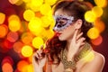 Beauty model woman wearing venetian masquerade carnival mask at party Royalty Free Stock Photo