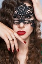 Beauty model woman wearing venetian masquerade carnival mask at party over holiday Royalty Free Stock Photo