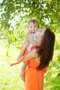 Beauty Mom and baby outdoors. Happy family playing in nature. Mo Royalty Free Stock Photo