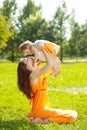 Beauty Mom and baby outdoors. Happy family playing in nature. Mo Royalty Free Stock Photo