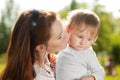 Beauty Mom and baby outdoors. Happy family playing in nature. Mo Royalty Free Stock Photo