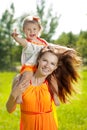 Beauty Mom and baby outdoors. Happy family playing in nature. Mo Royalty Free Stock Photo